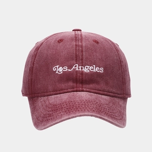 Detail of vintage washed burgundy cotton baseball cap with white Los Angeles embroidery