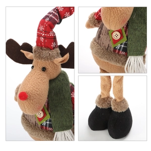 Close-up detail of plush reindeer doll with snowflake hat and knitted green scarf