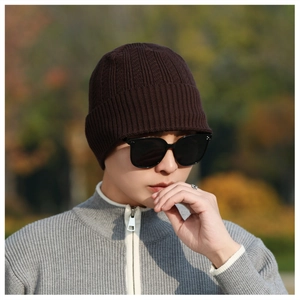 Detailed close-up of dark brown ribbed knit beanie for winter warmth and comfort