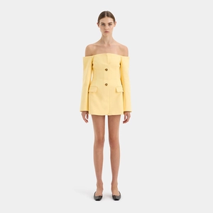 Detail of yellow off-shoulder blazer dress featuring long sleeves and double-breasted buttons