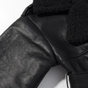 Close-up of premium black leather and thick plush faux fur texture on a jacket
