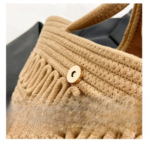Detail of the high-quality metal magnetic snap closure on the woven khaki tote bag