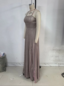 Close-up of rose gold sequin fabric on an evening dress with high slit and thin straps