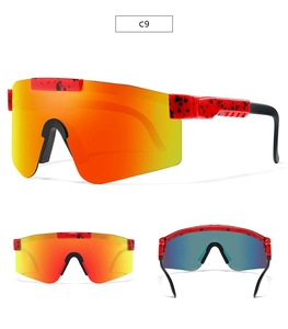 Detail view of red frame sports sunglasses with orange mirrored lenses and ink-splash pattern