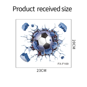 Detailed view of 3D football wall sticker breaking through a blue cracked wall surface