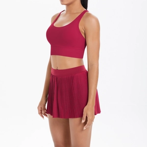 Detail of burgundy sports set featuring pleated tennis skirt and breathable racerback bra