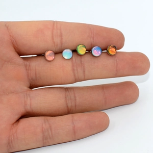 Set of 5 colorful round glitter oil-drop stainless steel tongue rings on hand