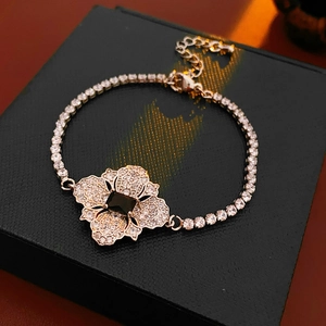 Detailed shot of flower bracelet with black square stone and clear zircons in rose gold