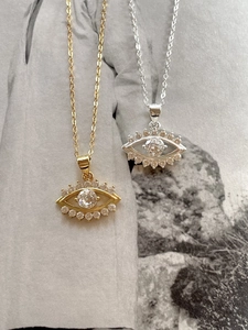 Detailed view of evil eye necklaces in gold and silver finish with sparkling zircon stones
