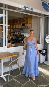 Detail of light blue two-piece set featuring ruffled camisole and maxi skirt in French style