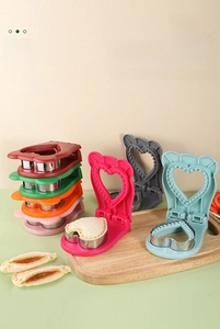 Macro shot of heart-shaped sandwich cutter mold with stainless steel blade and colorful plastic