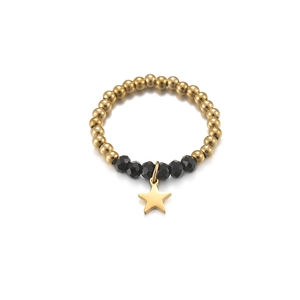 Macro detail of elastic bead ring with black faceted crystals and gold star charm