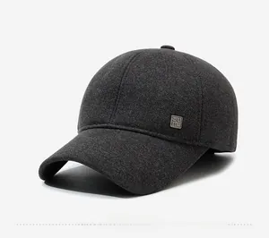 Detail view of charcoal grey winter baseball cap with twill fabric and metal side logo