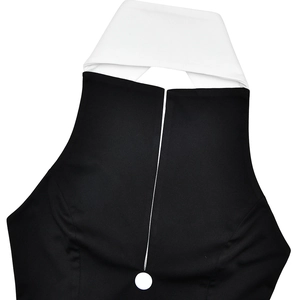 Detail of black dress with contrast white lapel collar and single white button closure