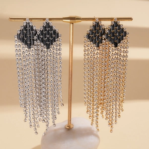 Luxury rhinestone tassel drop earrings in silver and gold displayed on a T-stand