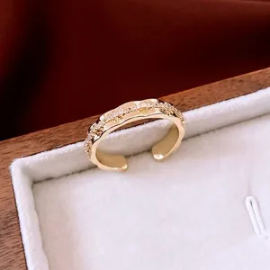 14K gold plated wavy open ring with sparkling white zircon accents in a wooden box