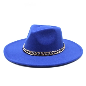 Detailed close-up of wide brim fedora with gold metal chain on royal blue felt