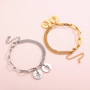 Detail of gold and silver paperclip bracelets with boy and girl cutout pendants