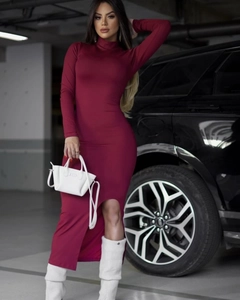 Detail of slim fit dark red high neck dress with side slit and long sleeves on model