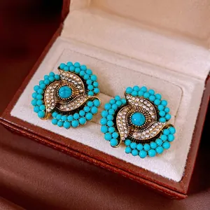 Bohemian vintage gold flower stud earrings with turquoise stones and white rhinestones