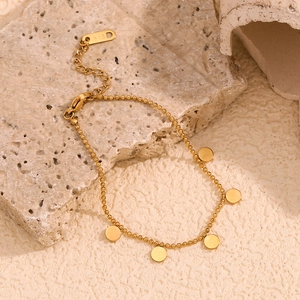 Close-up of 18K gold plated beaded chain bracelet with round pendants and K18 mark