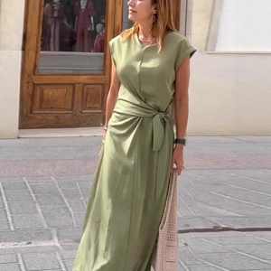 Detail of elegant olive green dress with waist tie and pleated details for summer style