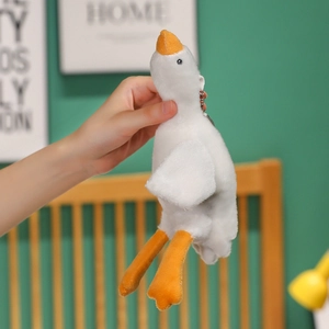 Detail of soft white goose plush keychain with orange beak and metal ring clip