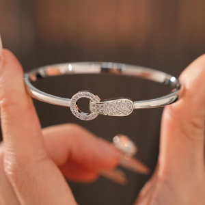 Detail of silver bangle with interlocking rings paved with sparkling cubic zirconia stones