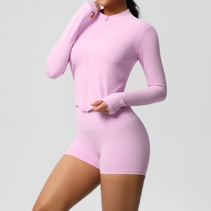 Close-up of pink yoga set showing thumb-hole cuffs and high-stretch matte fabric