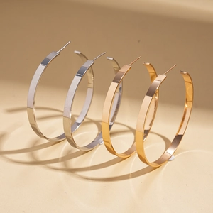Flat geometric round hoop earrings in polished gold and silver finishes for women