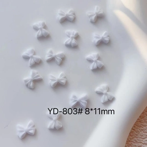 Detail view of white resin bow nail charms model YD-803 size 8x11mm for DIY nail art