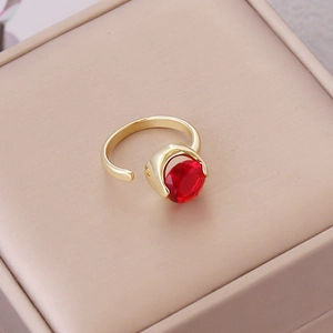 Detailed macro of red faceted zircon ring with adjustable gold plated open band