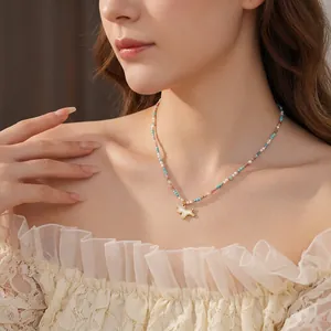 Chic unicorn pendant necklace with colorful gemstone beads and mother of pearl on a model