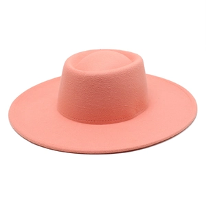 Close-up of coral pink wool felt flat top wide brim hat with detailed stitching finish
