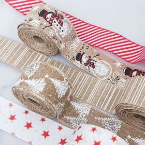 Detailed view of wired burlap Christmas ribbons featuring snowman and tree patterns