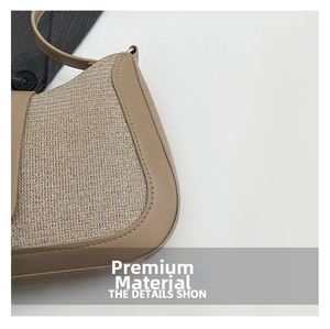 Detailed view of beige crescent bag featuring woven fabric and premium leather texture