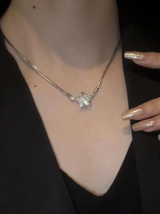 Close-up of sparkling star pendant with magnetic clasp on elegant silver chain