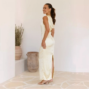 Detail of elegant slim-fit beige satin midi dress with back slit and high-gloss finish