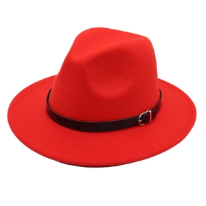 Detail of red fedora hat featuring black leather band and silver metallic buckle accessory