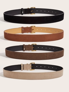 Detail showing four vintage suede waist belts in black, camel, brown, and beige with gold buckles