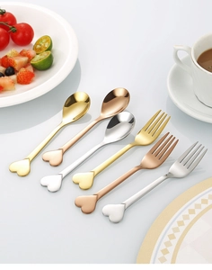 Polished heart-shaped stainless steel spoons and forks in gold, rose gold and silver