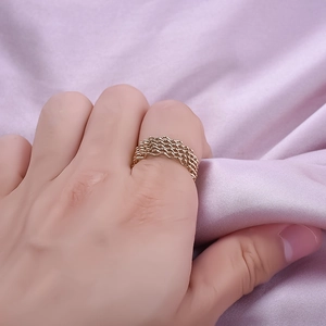 Elegant 18K gold plated stainless steel mesh woven ring on a soft silk background