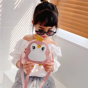 Close-up of pink penguin-shaped kids crossbody bag with detailed embroidery and PU leather texture