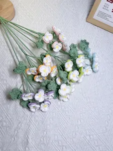 Detailed top-down view of colorful handmade crochet pansy bouquets with knit texture