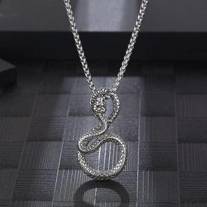 Vintage stainless steel snake pendant necklace with detailed scales on textured background