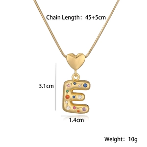 Detail view of 18K gold letter E pendant with multi-color zircons and exact dimensions