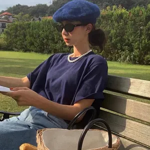 French style dark blue wool beret hat paired with classic round pearl necklace