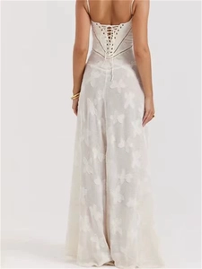 Elegant white backless maxi dress with criss-cross strappy details and subtle textures