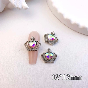 Macro detail of crown heart nail art charm with colorful rhinestones on silver base