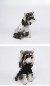 Detail of grey and black knit dog sweaters showing soft texture and Pawsitive label